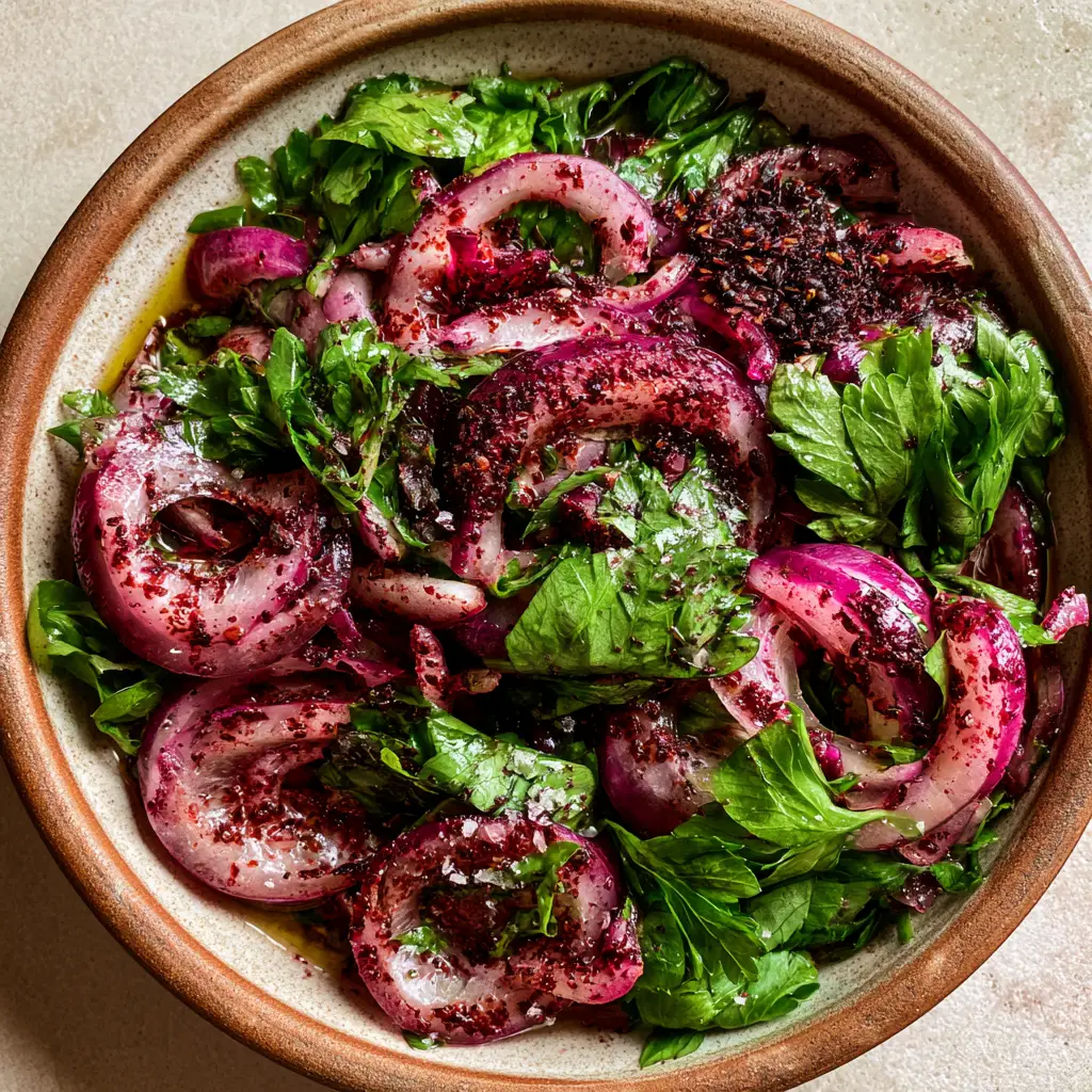 Turkish onion salad: The Authentic Sumac Onion Recipe (Sumaklı Soğan) 1 Close-up of Turkish sumac onions glistening with olive oil and lemon juice in soft afternoon sunlight.
