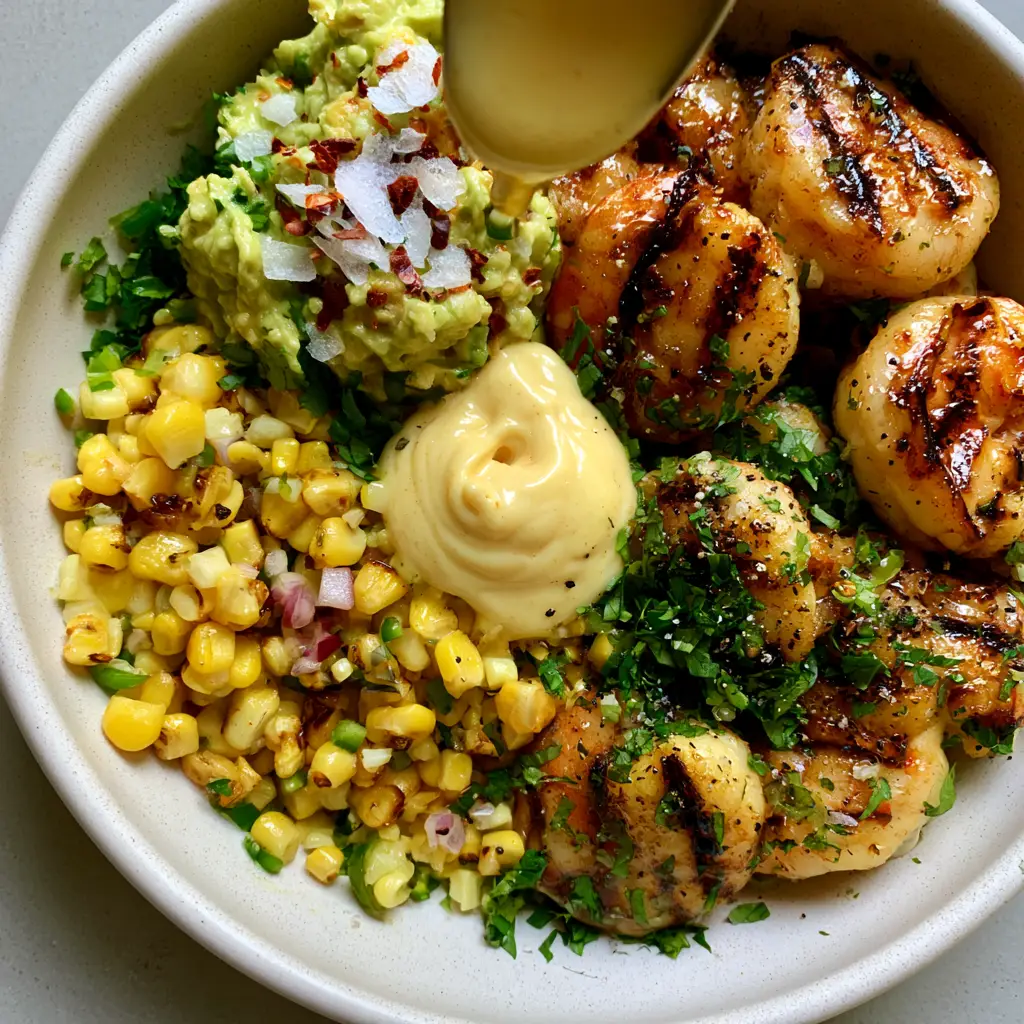 Grilled Shrimp Avocado Bowls with Honey-Lime Glaze and Garlic Drizzle 2 Extreme close-up of grilled shrimp avocado bowls showing honey-lime glaze and charred corn. (grilled shrimp avocado bowls)