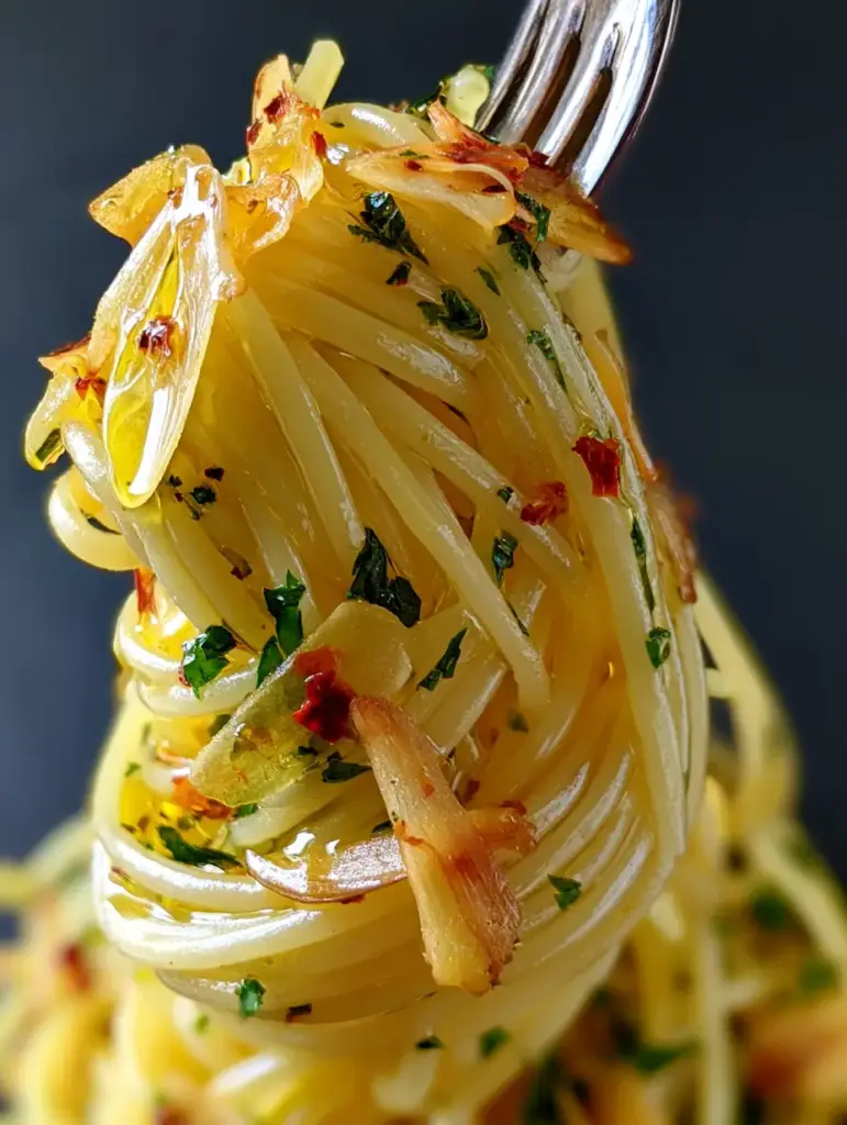 Spaghetti Aglio e Olio: The Ultimate Guide to Perfect Golden Garlic Pasta 1 Extreme close-up of spaghetti strands coated in olive oil with ruby-red chili flakes and emerald-green parsley.