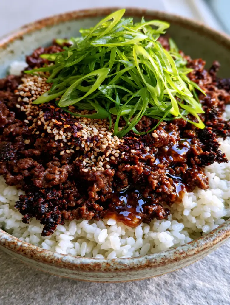 Ground Beef Bowl Recipes: The Ultimate Crispy Honey Garlic Beef Over Jasmine Rice 2 Close-up of seared crumbly ground beef with a thick dark amber honey garlic sauce on jasmine rice. (ground beef bowl recipes)