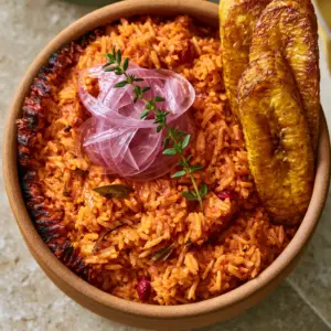 Extreme close-up of long-grain parboiled Jollof rice with visible scotch bonnet flecks and steam. (Nigerian lunch recipes)