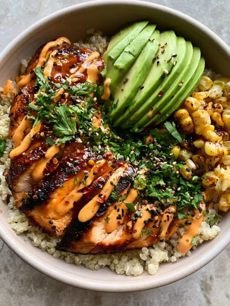 High Protein Dinners: Honey-Garlic Chicken and Quinoa Power Bowls 1 Close-up detail of seared honey-garlic chicken slices and charred corn in a quinoa bowl.