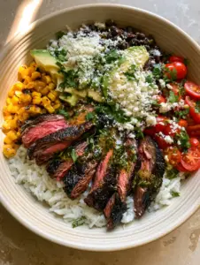 Close-up of seared steak strips with charred edges and pink centers in cilantro lime steak bowls.