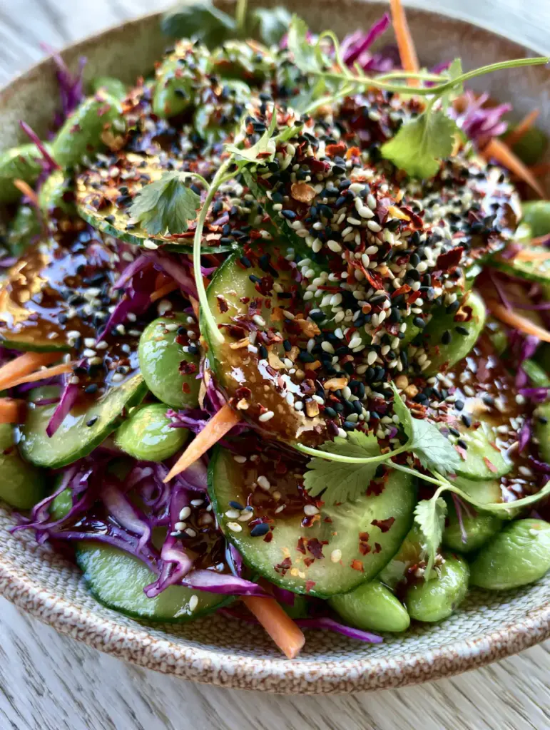 Cucumber Edamame Salad with Glossy Toasted Sesame Dressing 1 Finely shredded purple cabbage and julienned carrots mixed into a cucumber edamame salad.