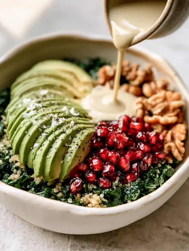 Handcrafted matte white bowl containing quinoa, pomegranate, and fanned avocado for glowing skin.