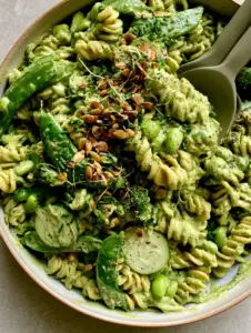 Overhead shot of Green Goddess Pasta Salad on a grey stone countertop with natural lighting.