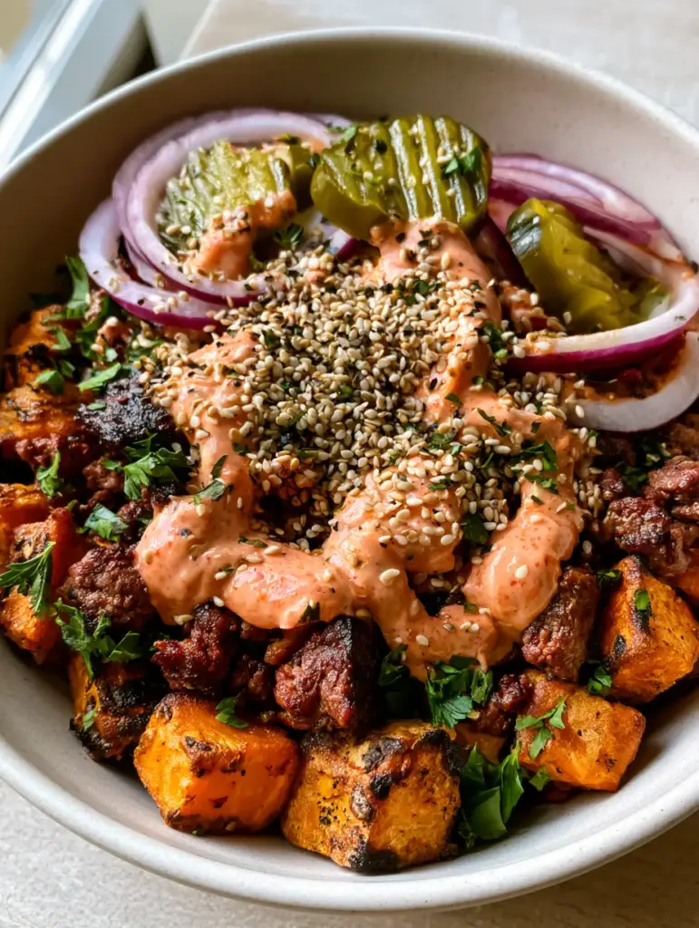 Sweet Potato Burger Bowl with Crispy Roasted Cubes and Special Sauce 1 Close-up of charred sweet potato cubes and seared ground beef in a burger bowl.