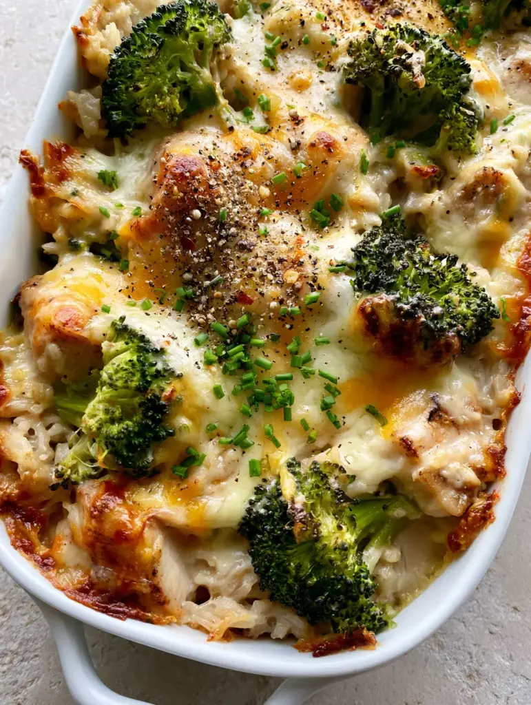 Broccoli Chicken and Rice Casserole: The Ultimate Cheesy Comfort Bake 1 High-angle view of the finished Broccoli Chicken and Rice Casserole with charred broccoli tops and fresh chives garnish.
