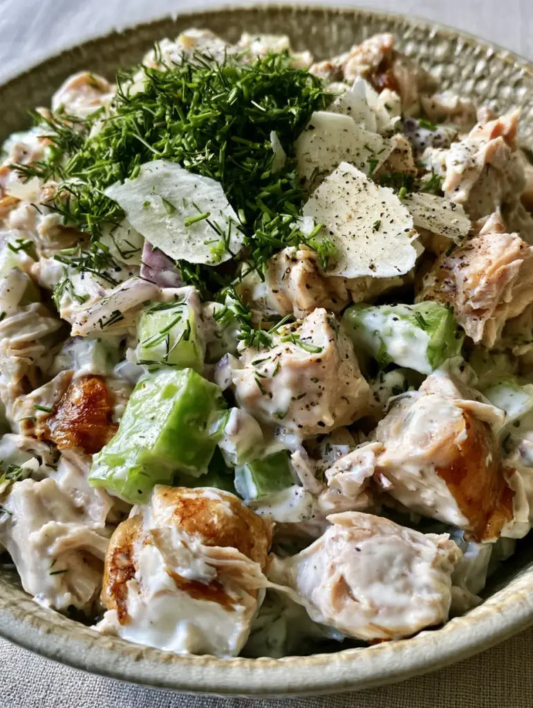 Rotisserie Chicken Salad with Creamy Greek Yogurt and Fresh Herbs 1 Top-down view of Rotisserie Chicken Salad garnished with fresh dill, chives, and flaky sea salt.