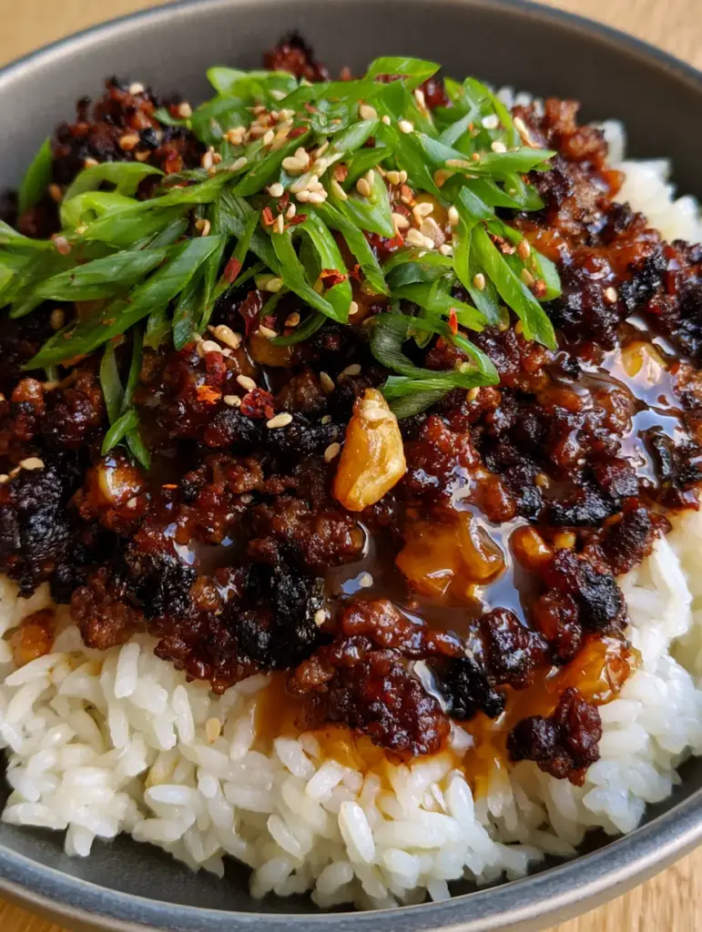 Honey Garlic Ground Beef Bowl with Crispy Caramelized Edges 2 Close-up of crispy seared ground beef with glistening amber honey garlic sauce and fresh scallions. (Honey Garlic Ground Beef Bowl)