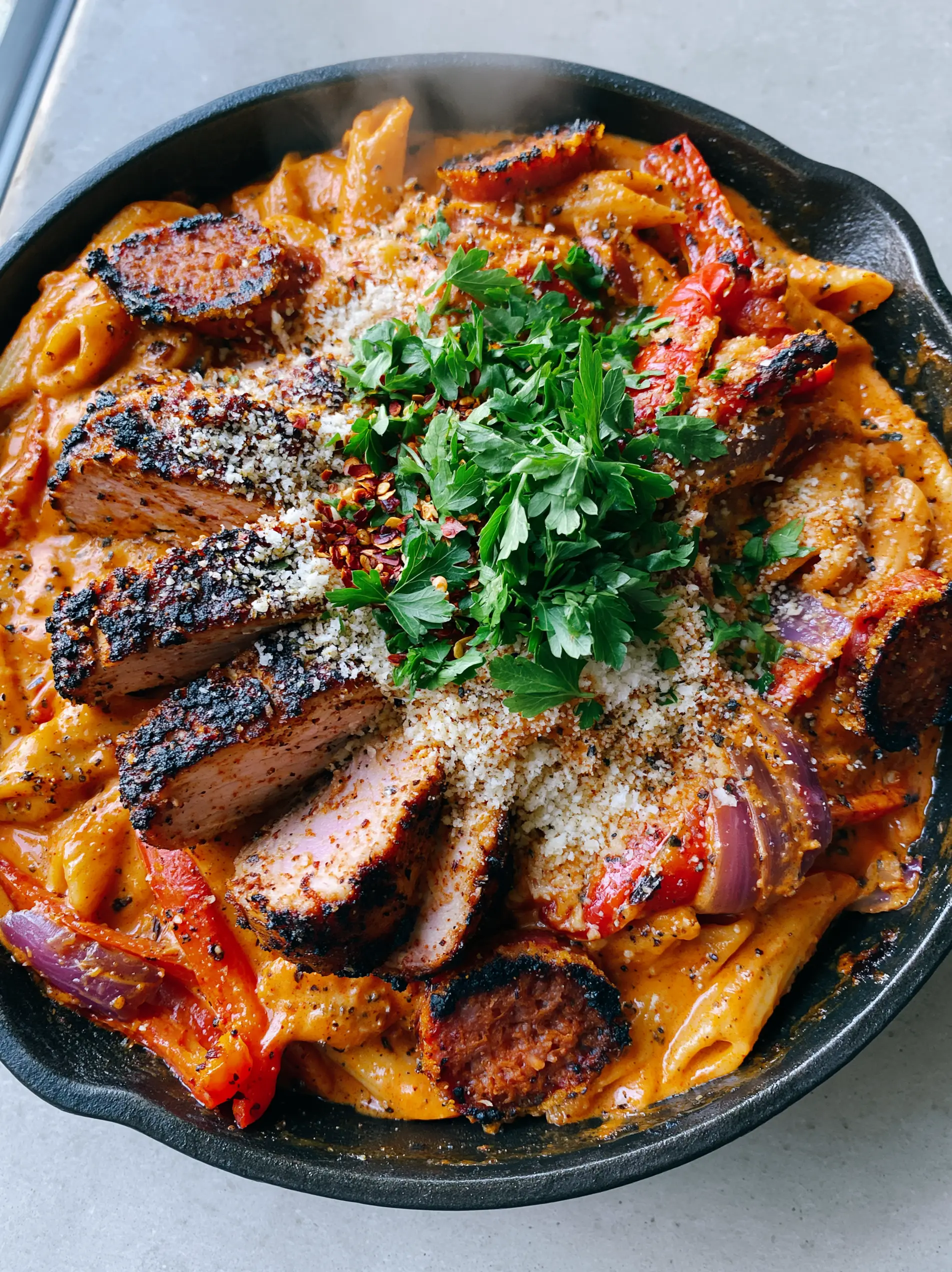 Creamy Cajun Pasta: The Ultimate Bold and Zesty Skillet Dinner 3 Close up of glossy Creamy Cajun Pasta sauce with visible flecks of black pepper and melted parmesan.