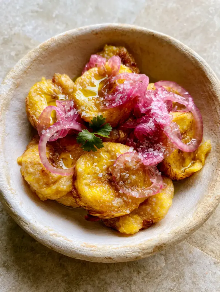 Boiled Green Plantains with Pickled Red Onions and Sea Salt 1 Close up of Boiled Green Plantains with glistening olive oil highlights and translucent onion rings.